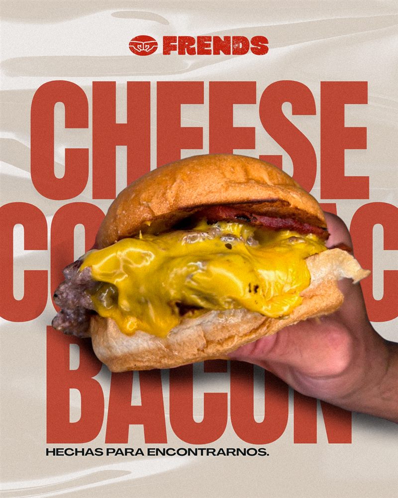 Frends Burger sostenida en la mano, con cheddar fundido
